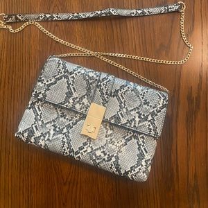 Animal print clutch with crossbody strap and gold accents